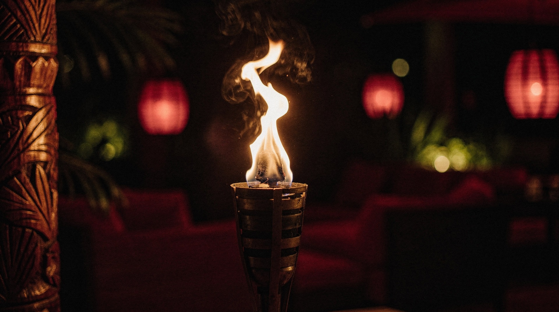 Tiki torch aglow at night